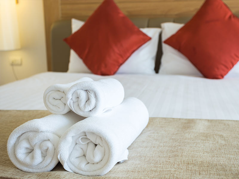 Towels rolled up on a bed